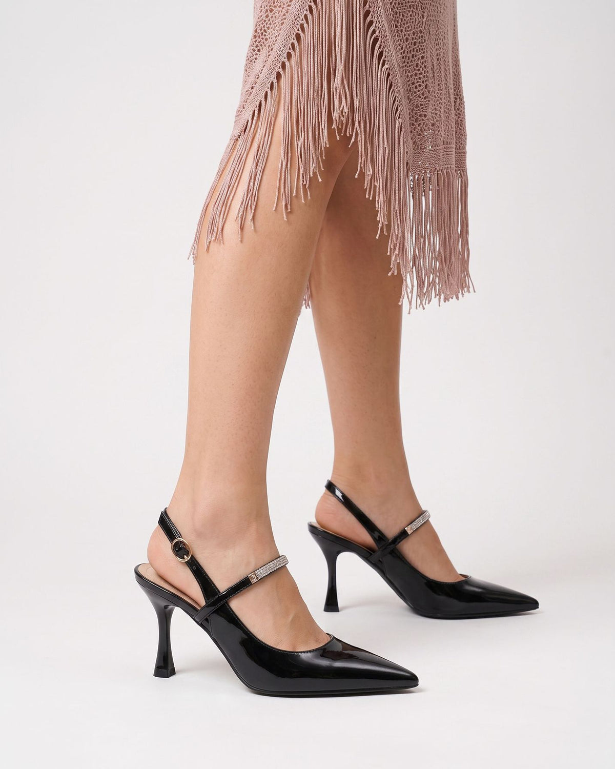Mescini black crystal strap pointed slingback pumps, worn on the model standing, close view, US women's sizes