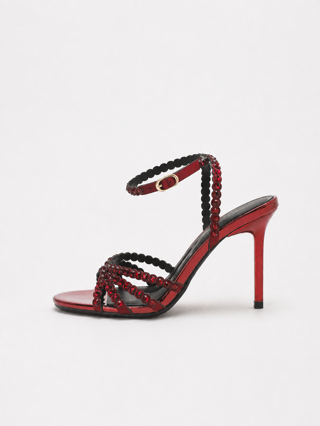 Mescini red rhinestone strappy stiletto sandals, one shoe photographed from the side, US women's sizes