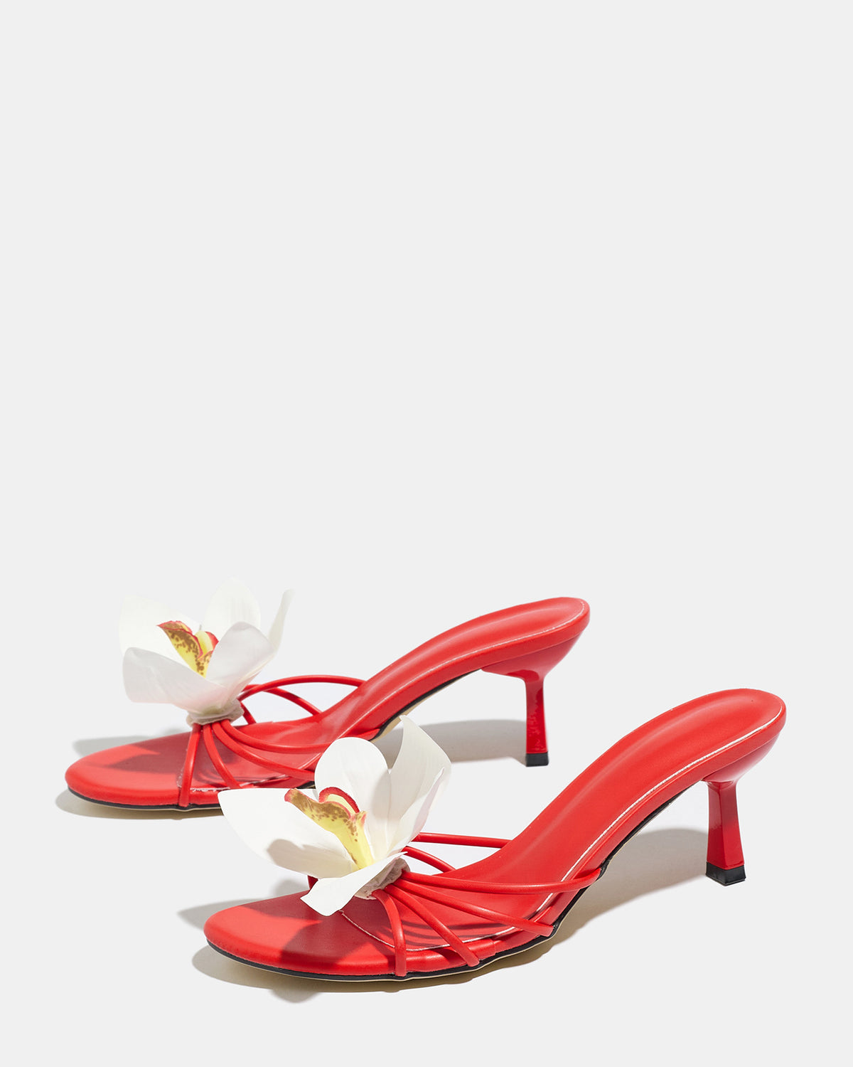 Mescini red orchid bloom strappy heeled mules, angled view of the pair on grey, US women's sizes