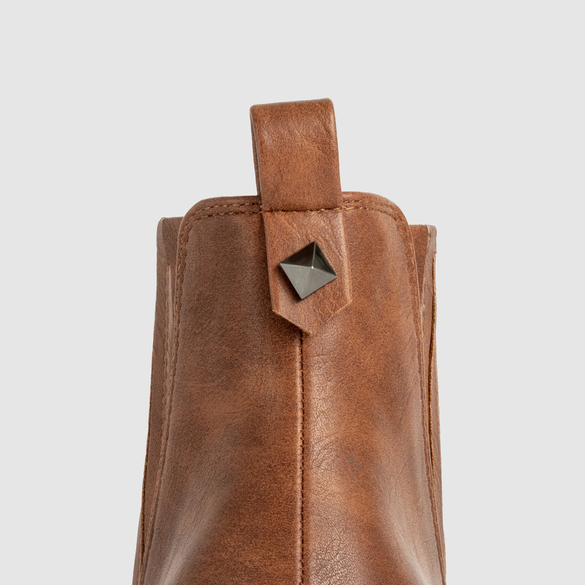 Mescini brown ankle boots, close-up of the back pull tab with its small pyramid stud
