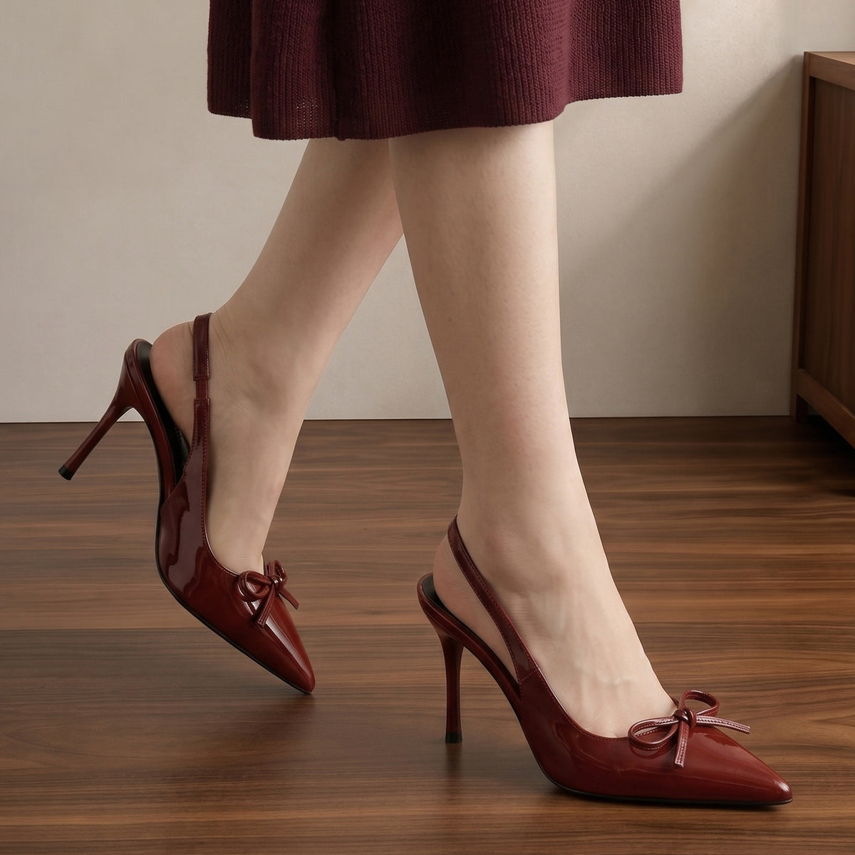 Mescini wine red patent bow slingback heels worn walking on a wooden floor, US women's sizes