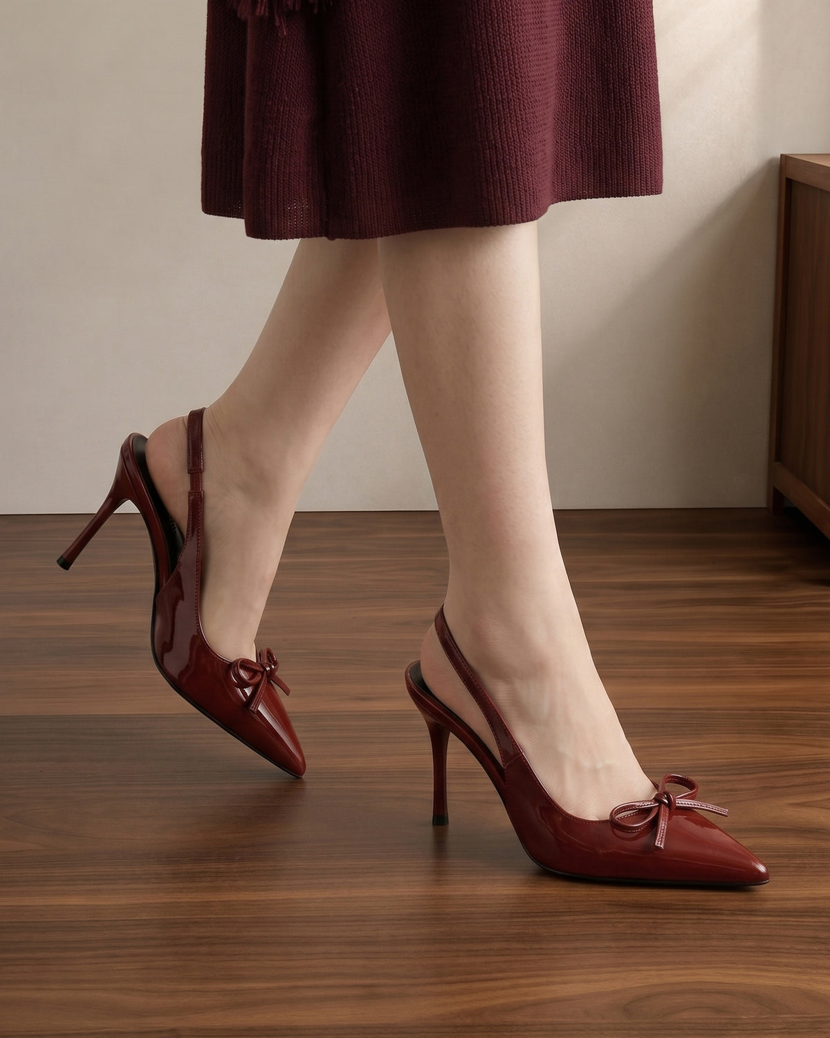 Mescini wine red patent bow slingback heels worn walking on a wooden floor, US women's sizes