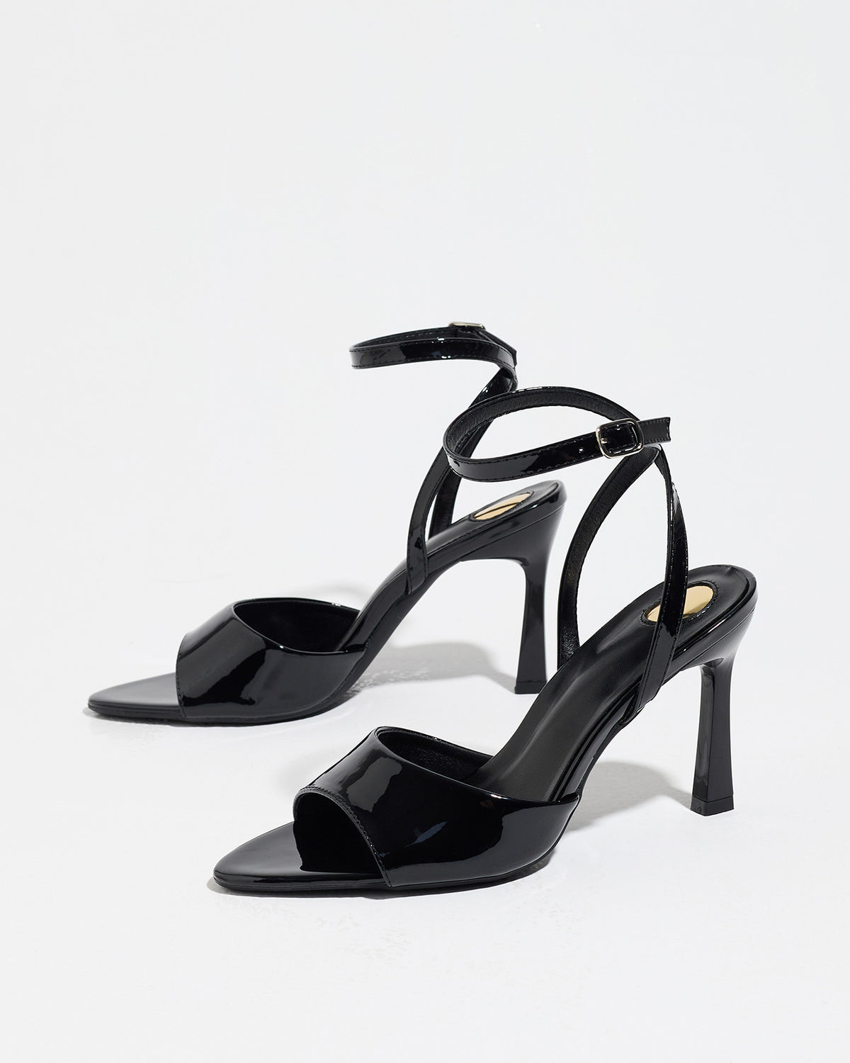 Mescini black single band ankle strap sandals, the pair standing at a slight angle, US women's sizes
