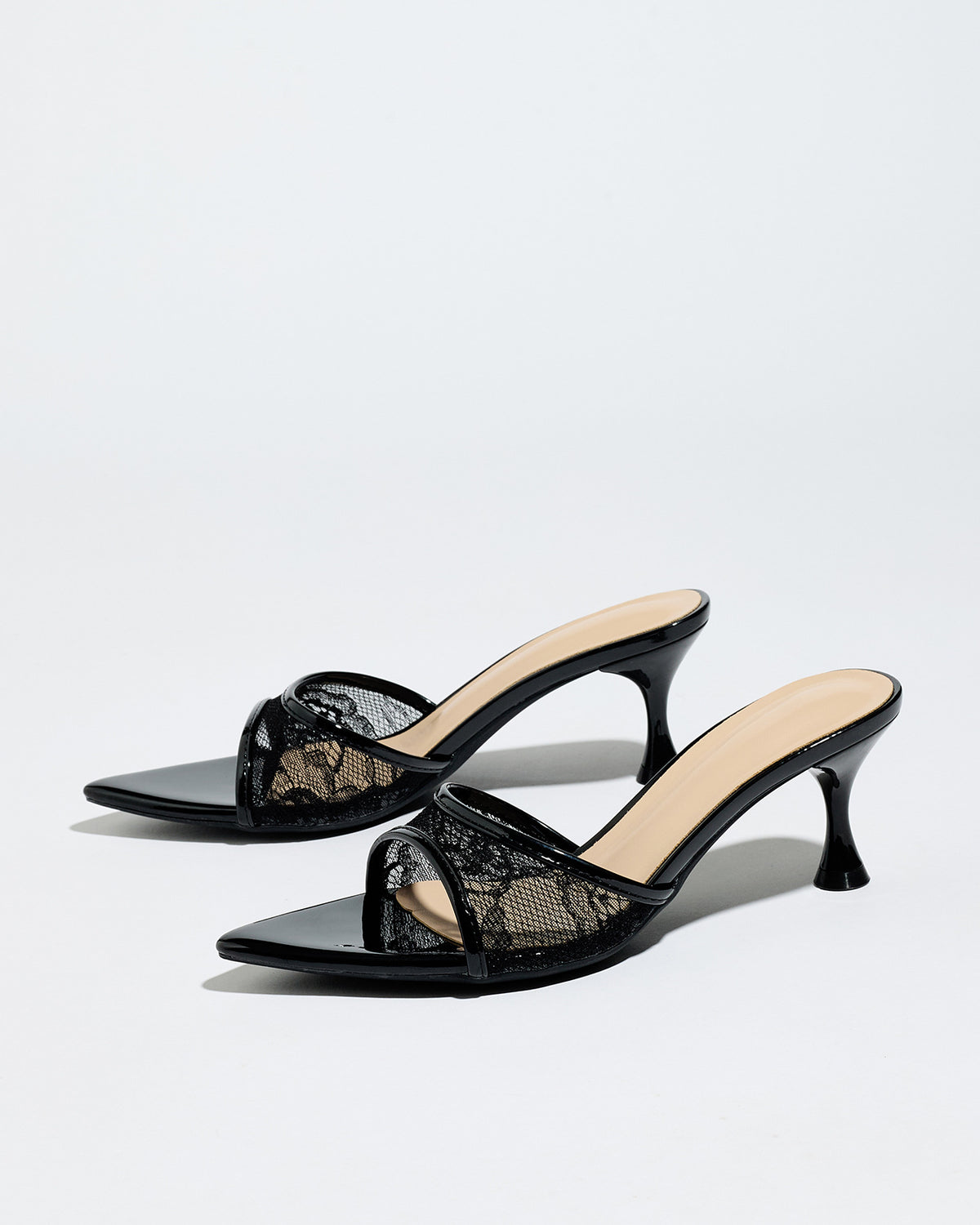 Mescini black sheer lace pointed toe mule heels, angled pair on a light grey surface, US women's sizes
