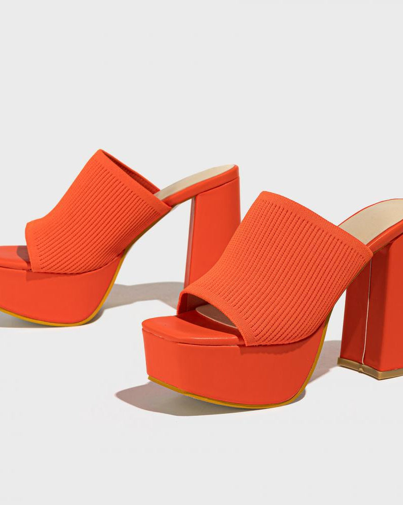 Mescini orange knit band platform mule heels, angled pair on a grey backdrop, US women's sizes