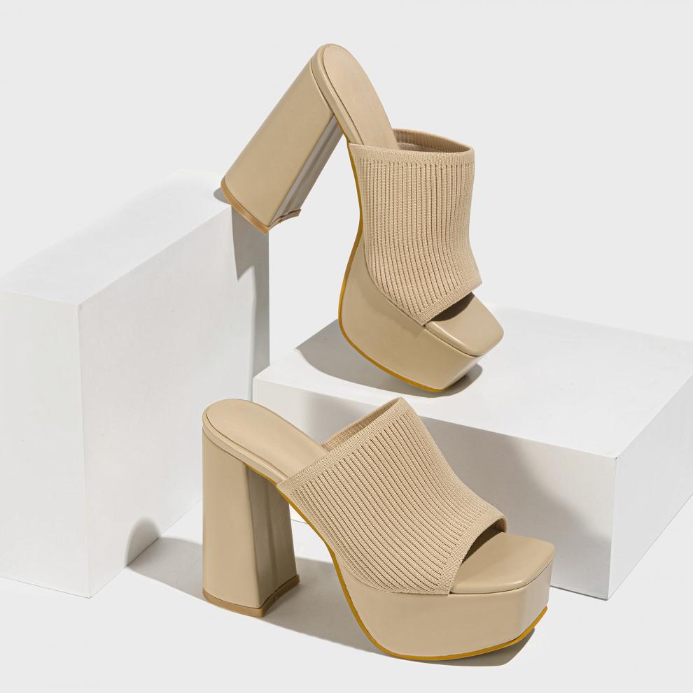 Mescini beige knit band platform mule heels, pair propped on white display blocks, US women's sizes