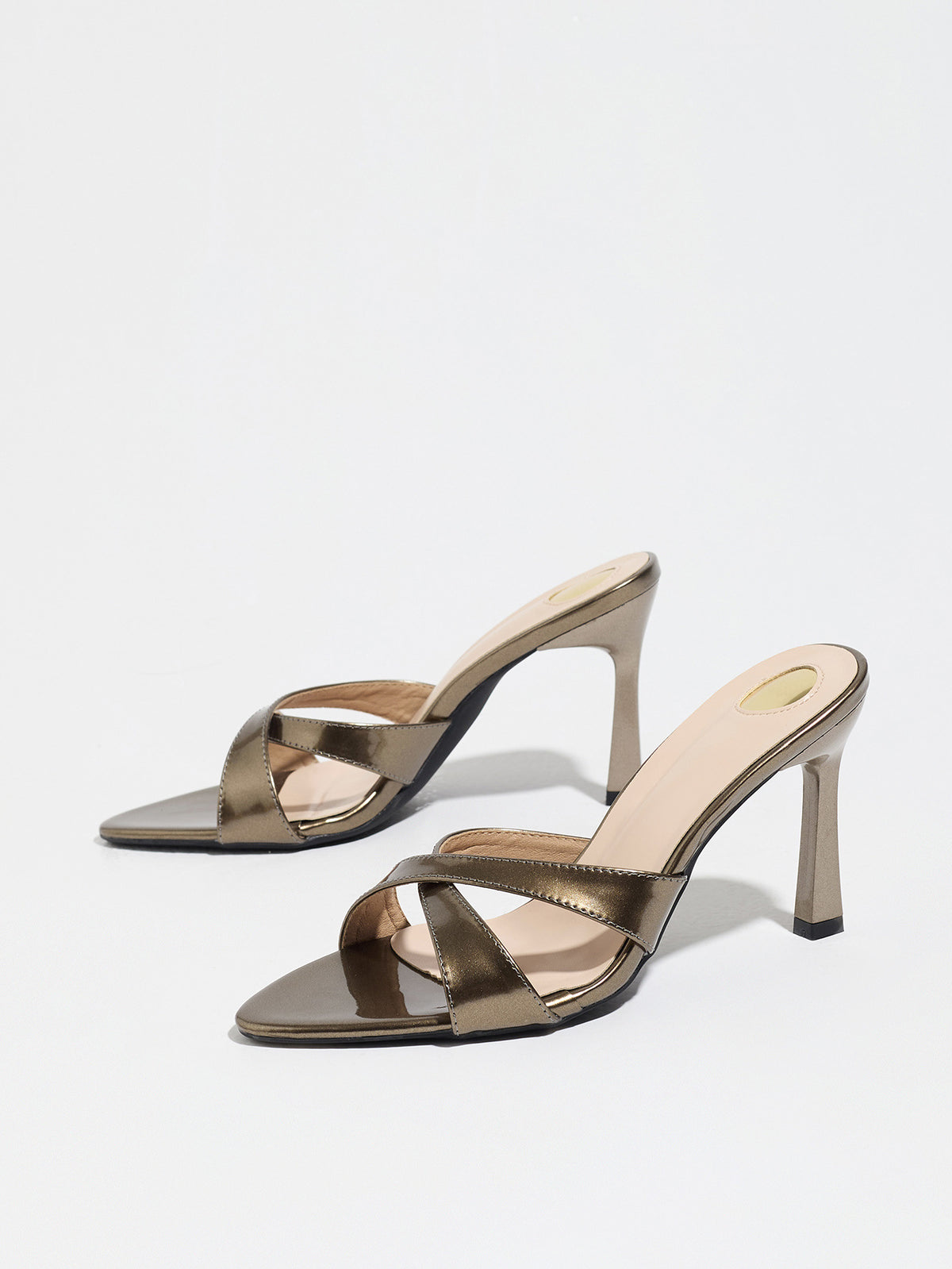 Mescini bronze cross strap stiletto mule sandals, pair angled on plain white, US women's sizes