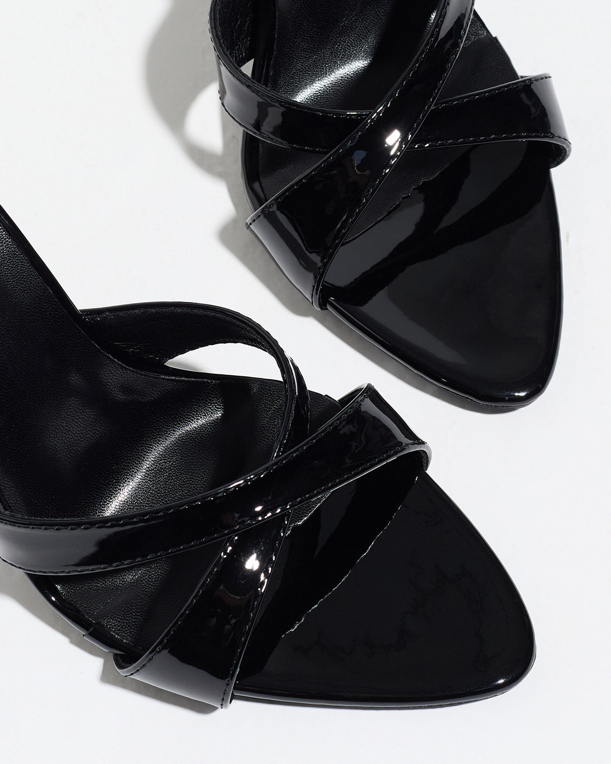 Mescini black cross strap stiletto mules, close up of the crossed patent bands, US women's sizes