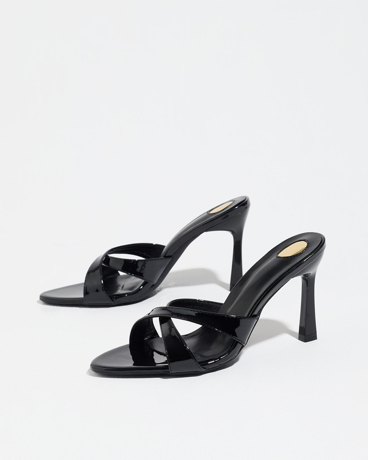 Mescini black cross strap stiletto mule sandals, pair angled on a white backdrop, US women's sizes