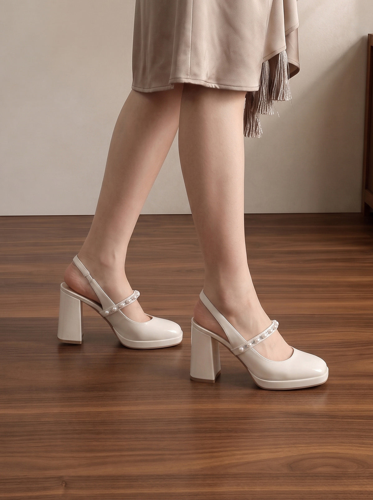 Mescini white pearl strap platform mary jane heels, worn on a model standing on wood, US women's sizes