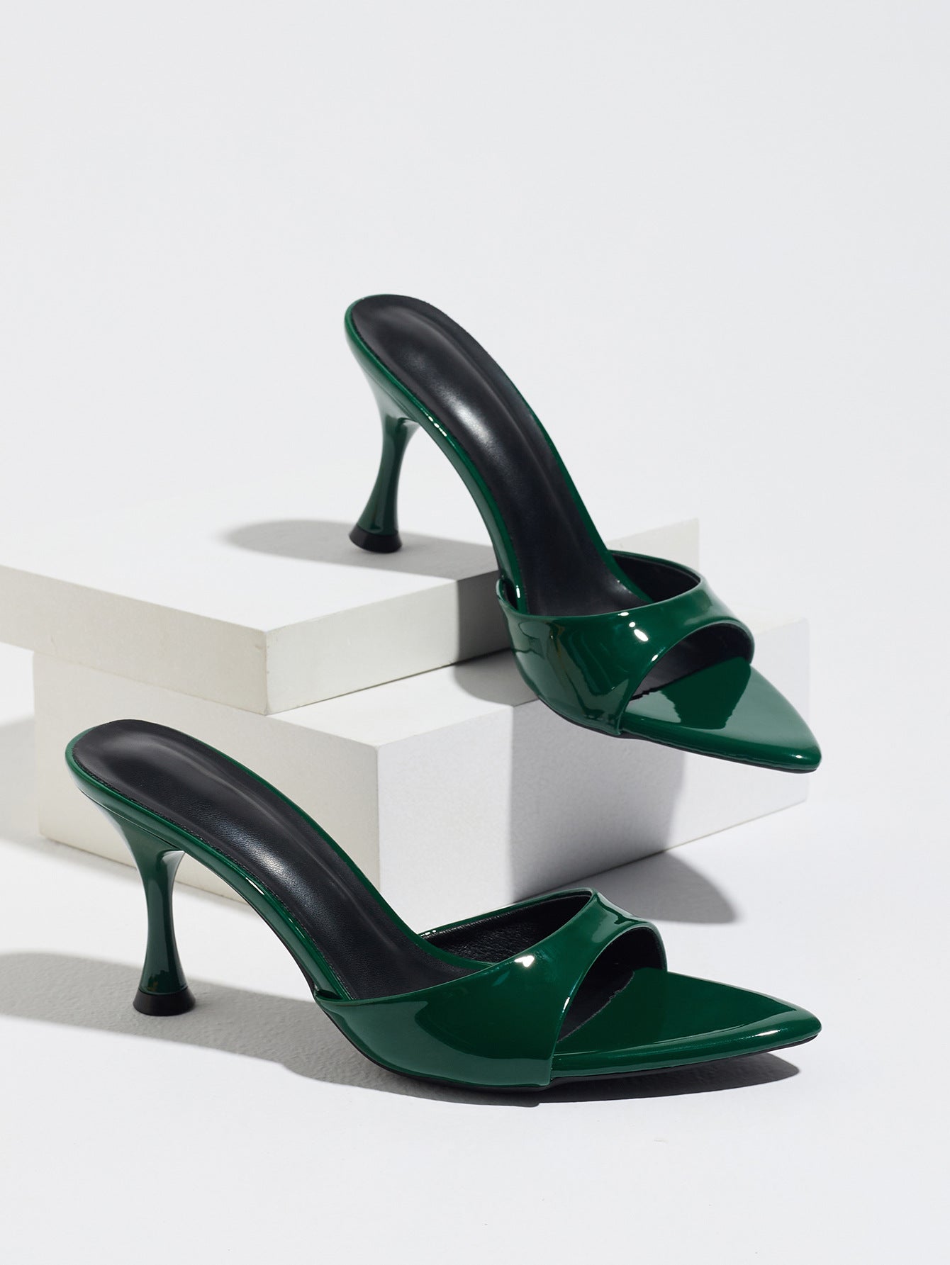 Mescini - Green pointed toe mule heels as a pair on white risers, studio view, US sizes