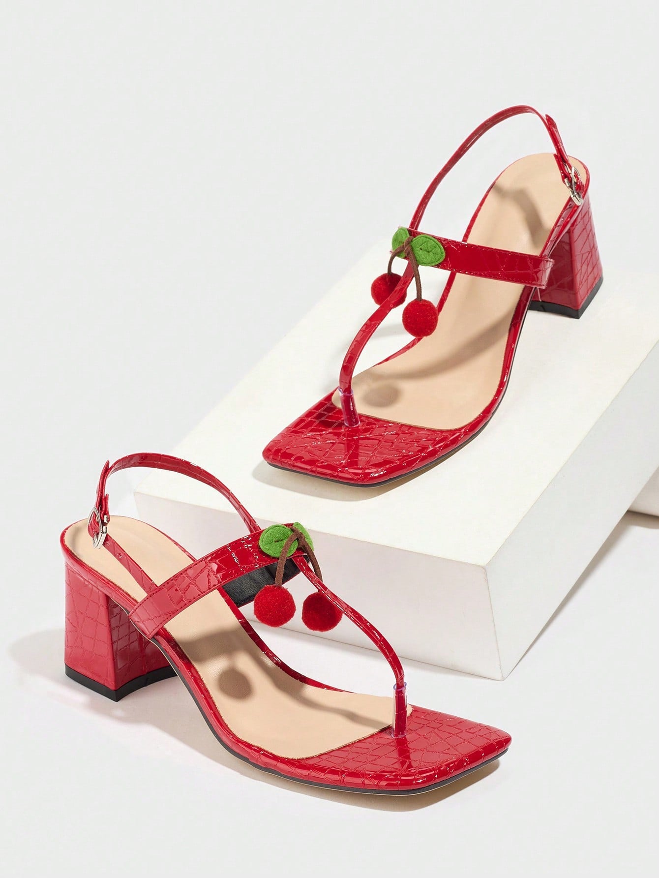 Mescini - Red square toe block heel sandal pair on a white riser, studio view, US sizes