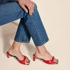 Mescini - Red peep toe block heel mules worn with cropped denim, standing view, US sizes