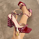 Mescini - Burgundy polka dot block heel sandal held in hand, square toe cap view, US sizes