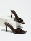 Mescini - Mocha pointed toe mule heels as a pair on white risers, studio view, US sizes