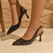Mescini - Black patent slingback heel pair on a stone floor, three quarter view, US sizes