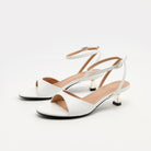 Mescini - White ankle strap sandals pair photographed at a three quarter angle, US women's sizes