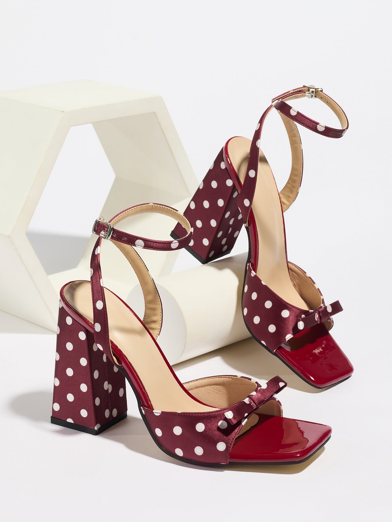 Mescini - Burgundy polka dot block heel sandal pair on a white riser, studio view, US