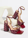Mescini - Burgundy polka dot block heel sandal pair on a white riser, studio view, US