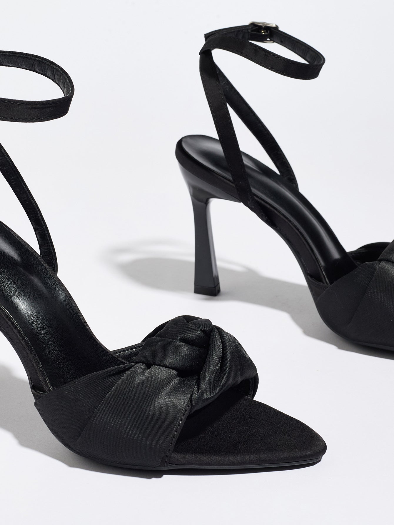 Mescini black knotted satin ankle strap sandals, close up of one shoe at an angle, US women's sizes