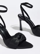 Mescini black knotted satin ankle strap sandals, close up of one shoe at an angle, US women's sizes