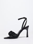 Mescini black knotted satin ankle strap sandals, single shoe in profile on white, US women's sizes