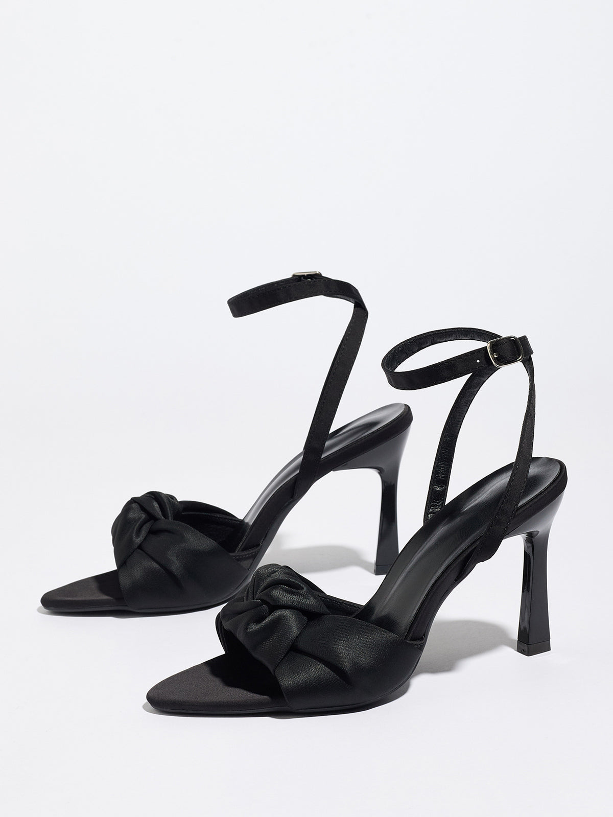 Mescini black knotted satin ankle strap sandals, pair angled on a plain surface, US women's sizes