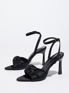 Mescini black knotted satin ankle strap sandals, pair angled on a plain surface, US women's sizes