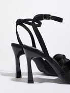 Mescini black knotted satin ankle strap sandals, rear view of the heel and buckle, US women's sizes