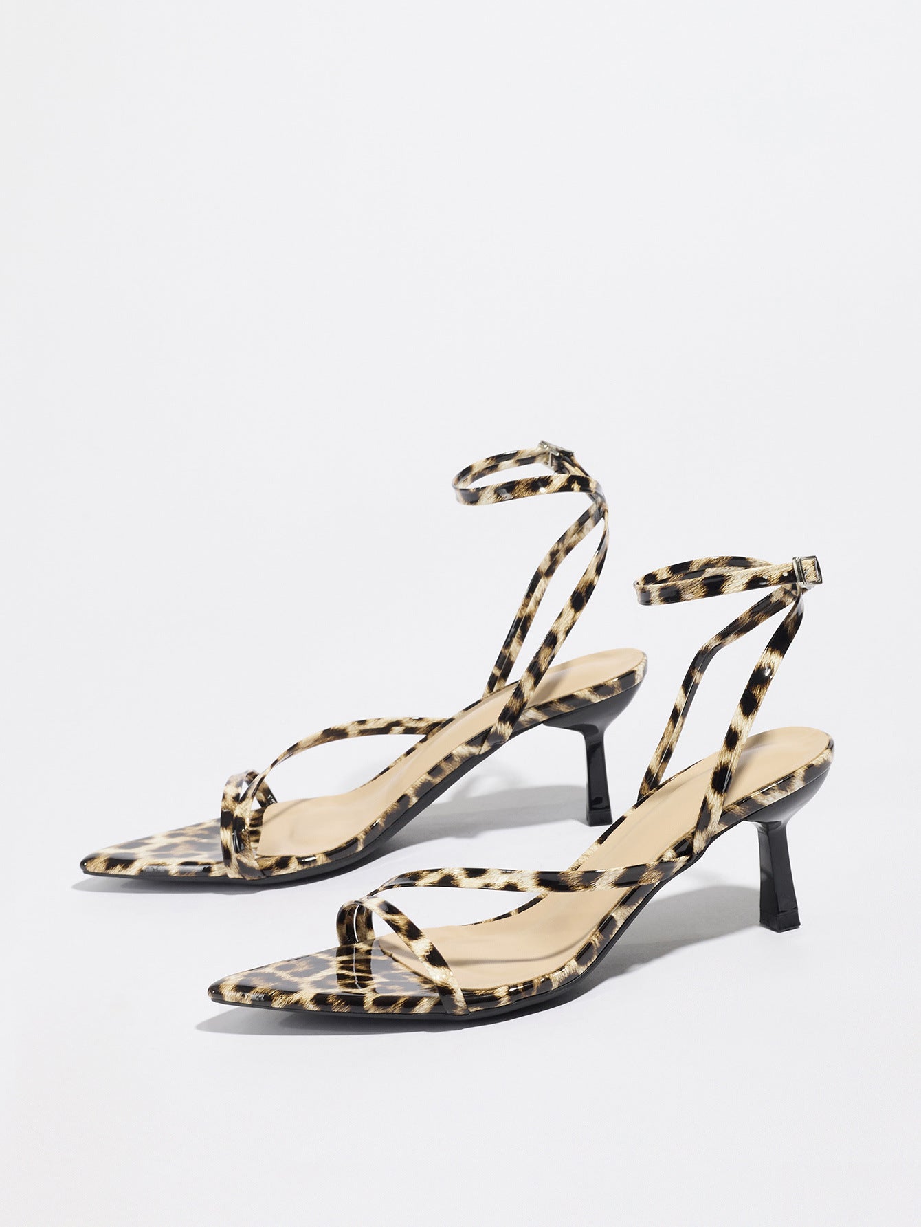 Mescini leopard print strappy heeled sandals, angled pair on a white studio floor, US women's sizes