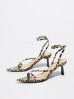 Mescini leopard print strappy heeled sandals, angled pair on a white studio floor, US women's sizes