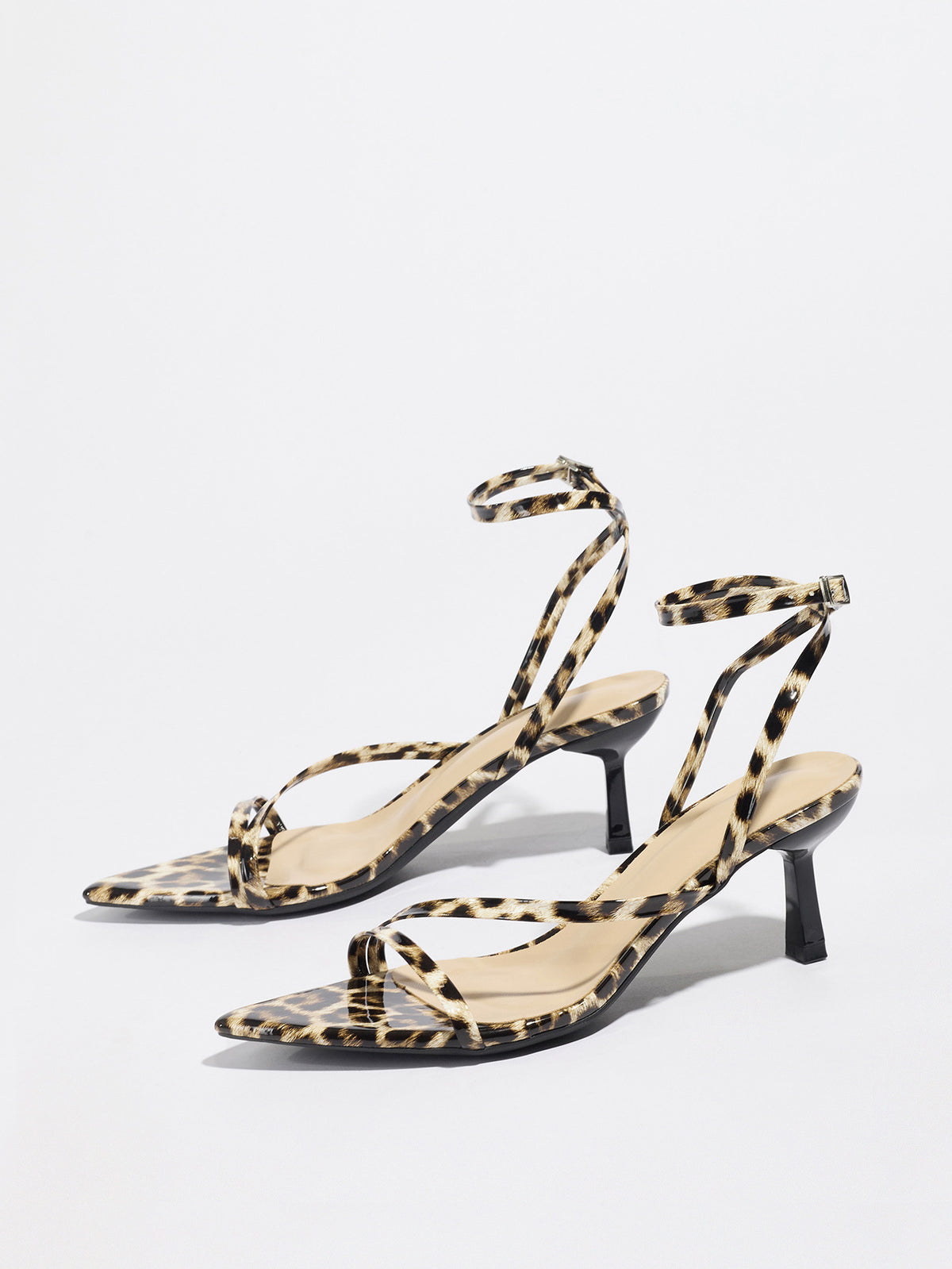 Mescini leopard print strappy heeled sandals, angled pair on a white studio floor, US women's sizes