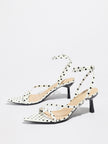 Mescini white polka dot strappy heeled sandals, angled pair on a grey floor, US women's sizes