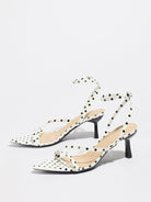 Mescini white polka dot strappy heeled sandals, angled pair on a grey floor, US women's sizes