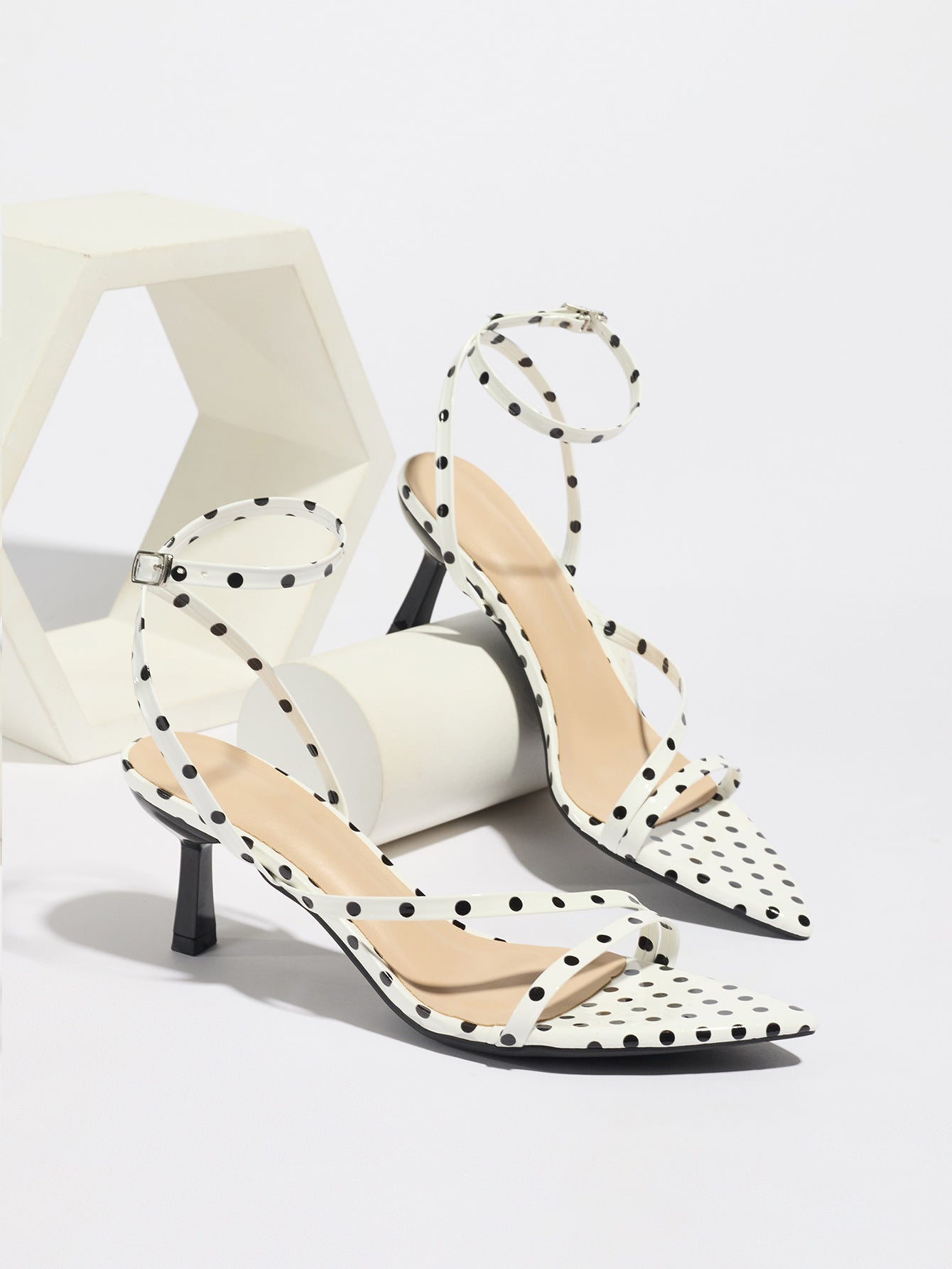 Mescini white polka dot strappy heeled sandals, pair propped on pale blocks, US women's sizes