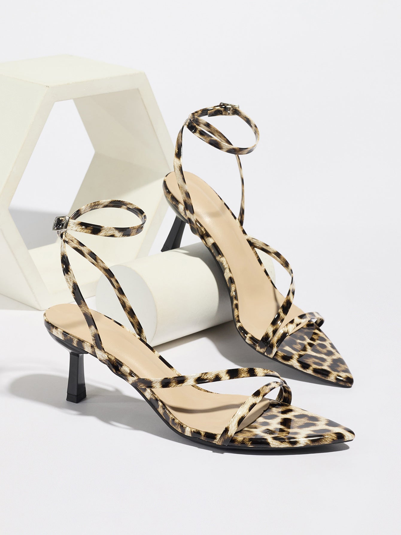 Mescini leopard print strappy heeled sandals, pair propped on white blocks, US women's sizes