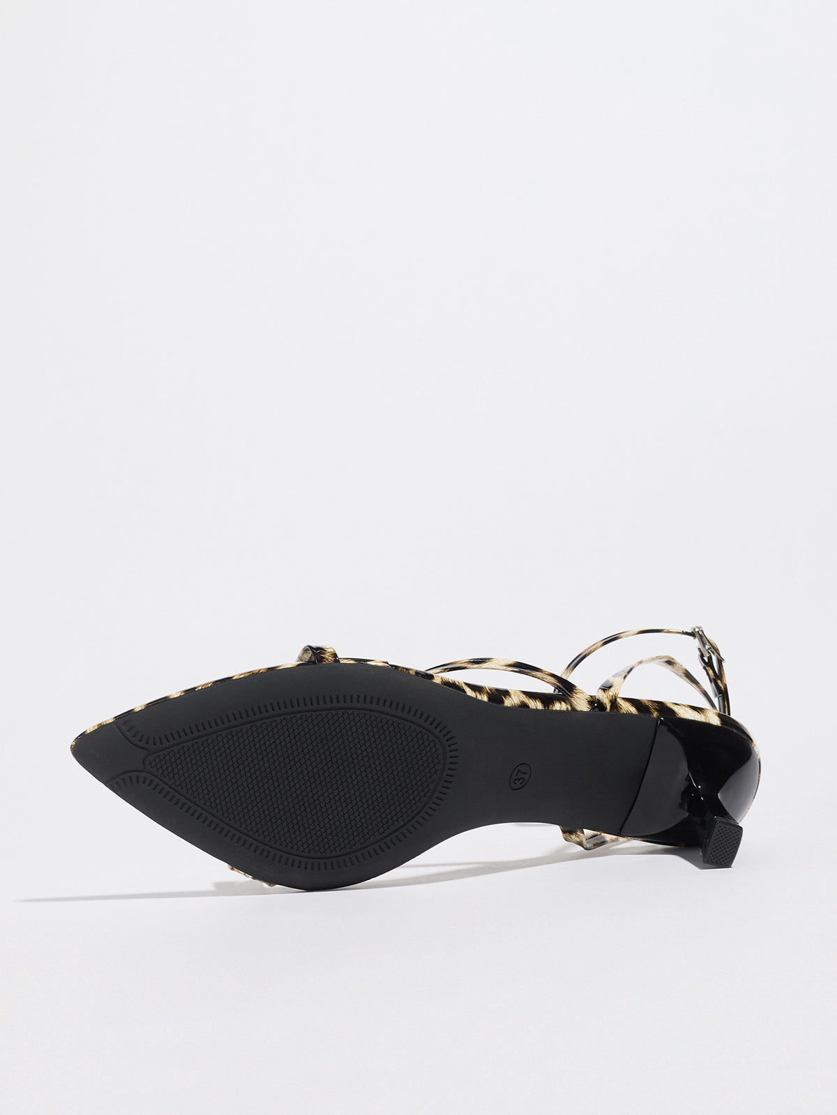 Mescini leopard print strappy heeled sandal on its side, close view of the outsole, US women's sizes