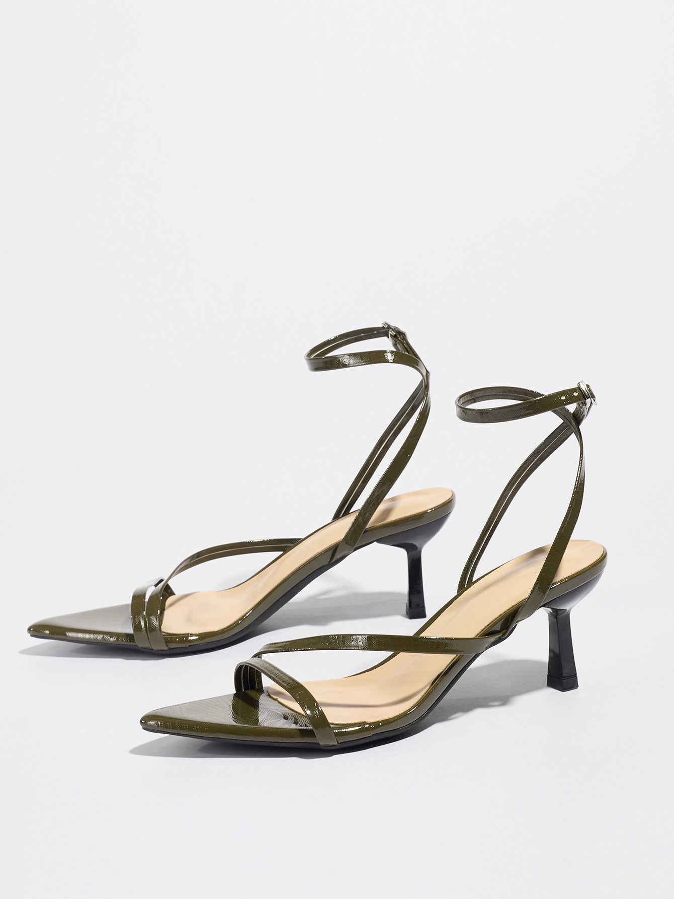 Mescini olive strappy heeled sandals, angled pair on a white studio floor, US women's sizes