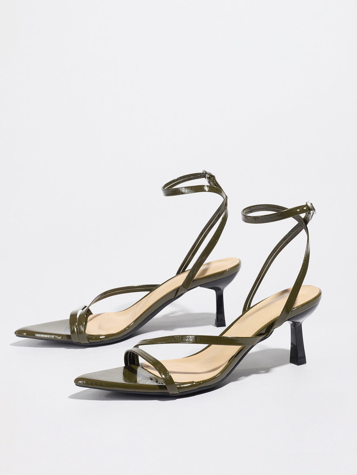 Mescini olive strappy heeled sandals, angled pair on a white studio floor, US women's sizes