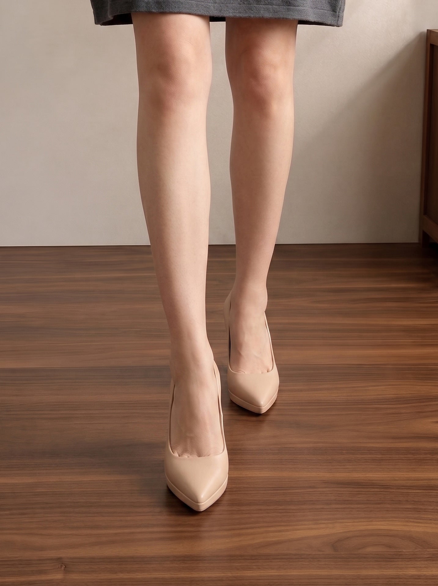 Mescini nude sculpted heel pointed toe pumps, worn walking towards the camera, US women's sizes