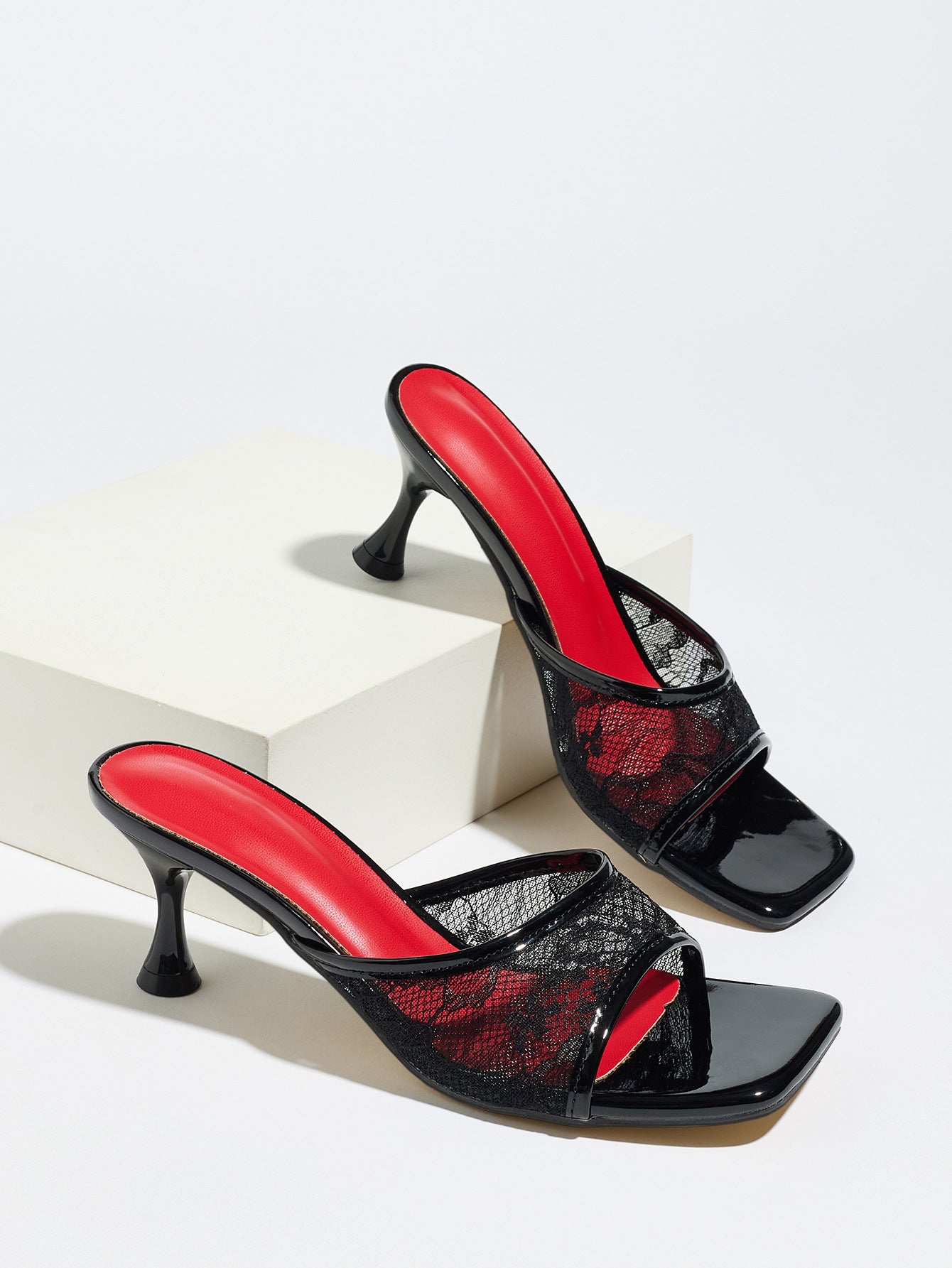 Mescini black lace mesh square toe mule heels, pair posed on a white display block, US women's sizes