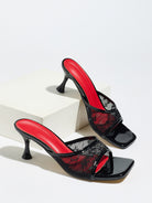 Mescini black lace mesh square toe mule heels, pair posed on a white display block, US women's sizes