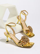Mescini gold rosette square toe strappy sandals, pair posed beside a white block, US women's sizes