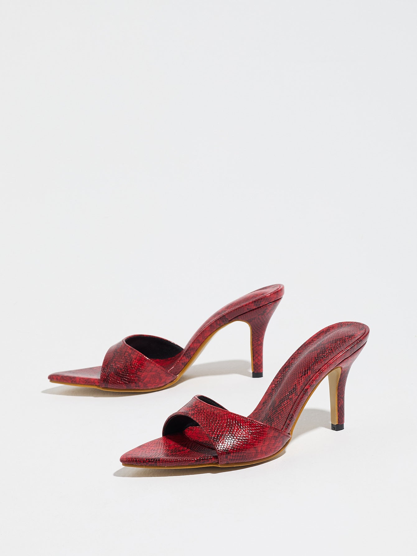 Mescini red snake print pointed toe mule heels, low angle view of both shoes, US women's sizes