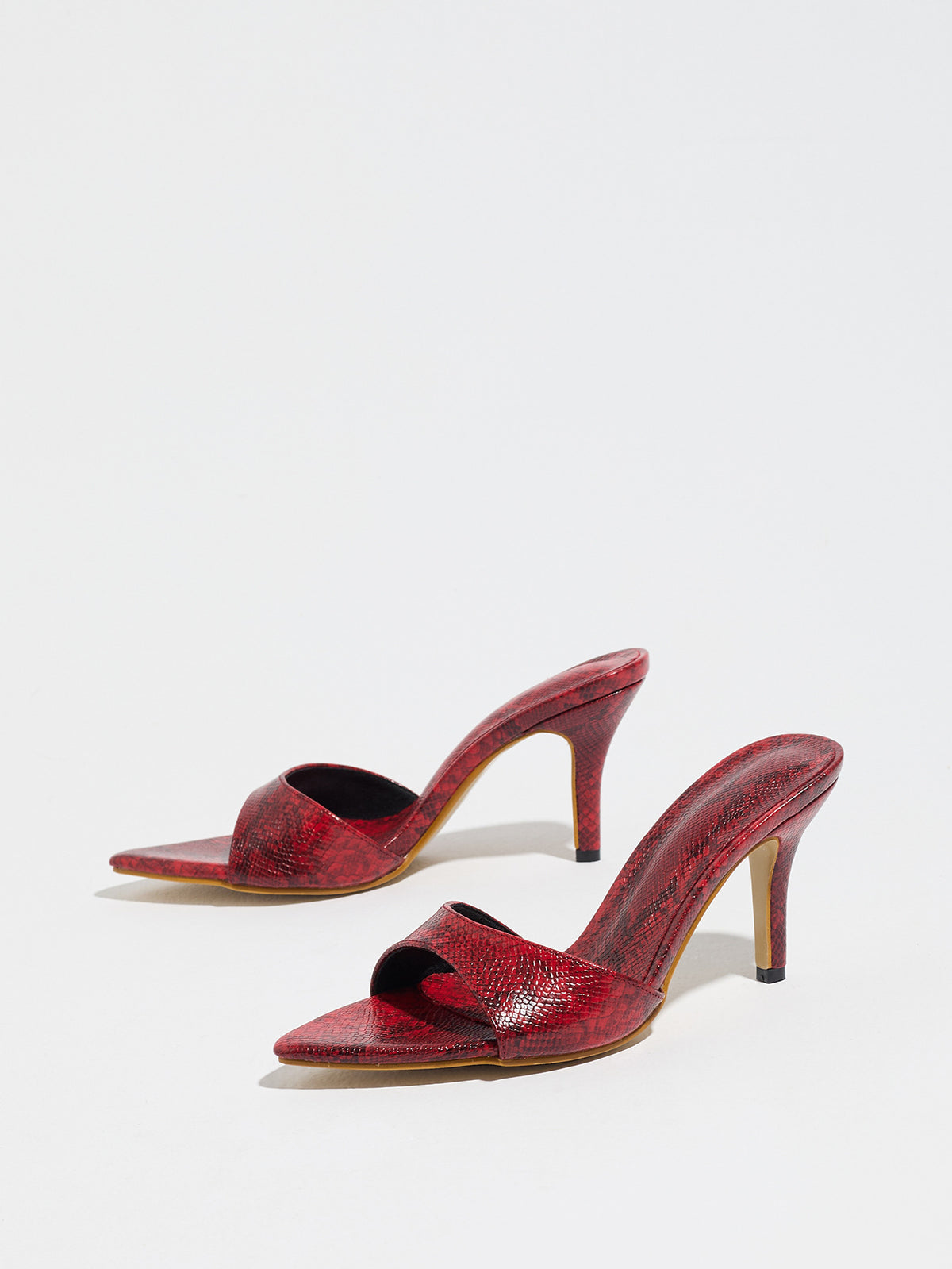 Mescini red snake print pointed toe mule heels, low angle view of both shoes, US women's sizes