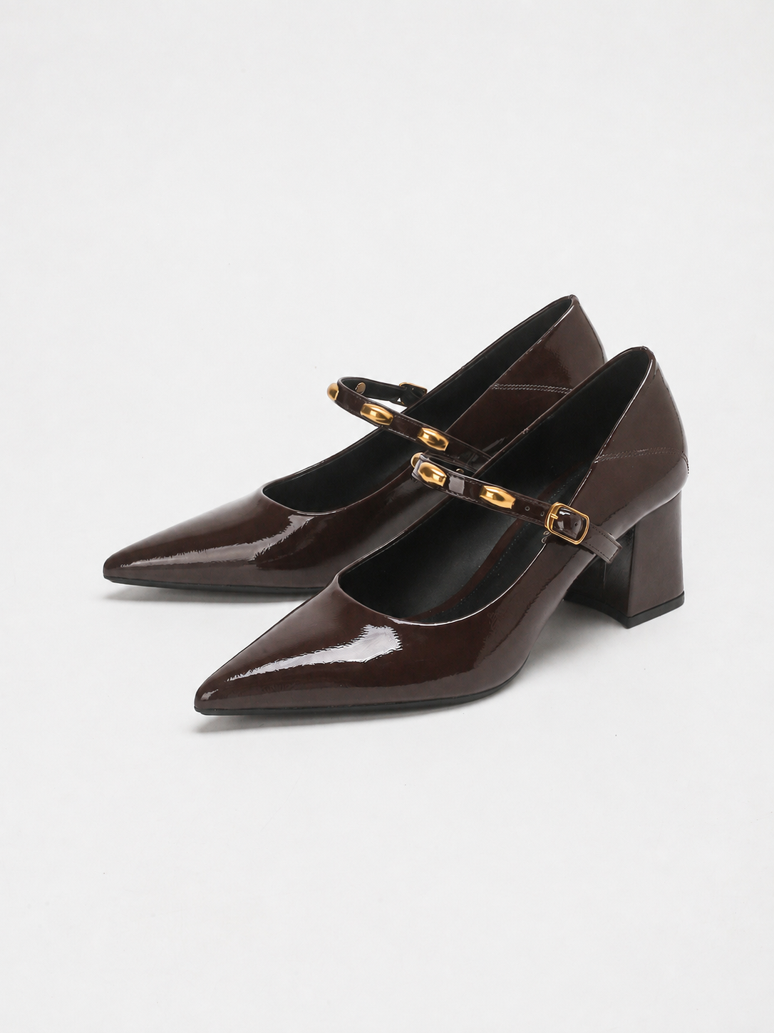 Mescini brown studded strap Mary Jane heels, pair angled on a white background, US women's sizes