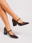 Mescini brown studded strap Mary Jane heels, worn with legs crossed and one foot raised, US women's sizes