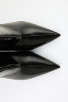 Mescini black pointed toe ankle boots, pair seen from above, shafts open, US sizes