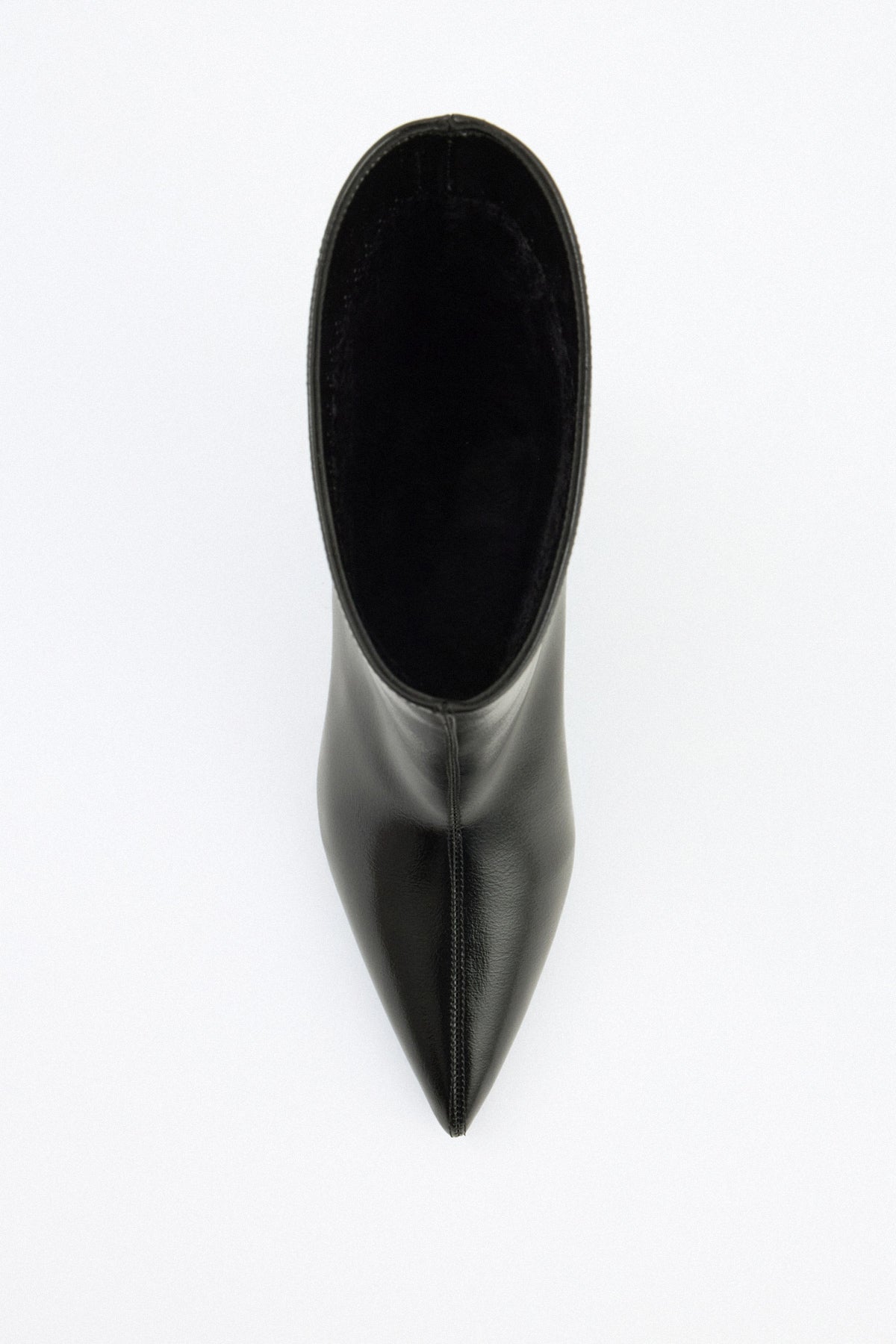 Mescini black pointed toe ankle boots, worn mid stride, heel lifted, US size guide