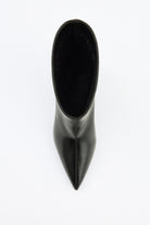 Mescini black pointed toe ankle boots, worn mid stride, heel lifted, US size guide